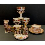 Royal Crown Derby - 1128 pattern, including; three goblets, twin handled loving cup, table bell, cat