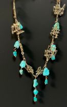 A modernist 9ct gold and turquoise fringe necklace, of eight free form wire bar panels, divided by