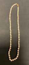 A single strand creamy white cultured pearl necklace, with an 18ct gold clasp