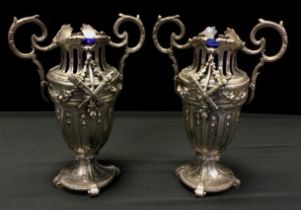 A pair of late 19th century French silver plated twin-handled vases, pierced and cast in relief,28cm