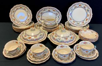 A Masons dinner service for eight, decorated with a floral border including; two graduated meat