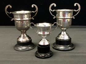 A twin handled silver trophy, John Turton & Co, Sheffield 1960, another similar 1963, another