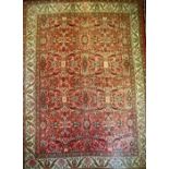 A large Iranian/Persian hand knotted mahal carpet in tones of blue, green, ochre and red on a