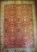 A large Iranian/Persian hand knotted mahal carpet in tones of blue, green, ochre and red on a