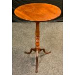 An early 20th century mahogany tall tilt-top table, circular top, turned column, carved tripod feet,