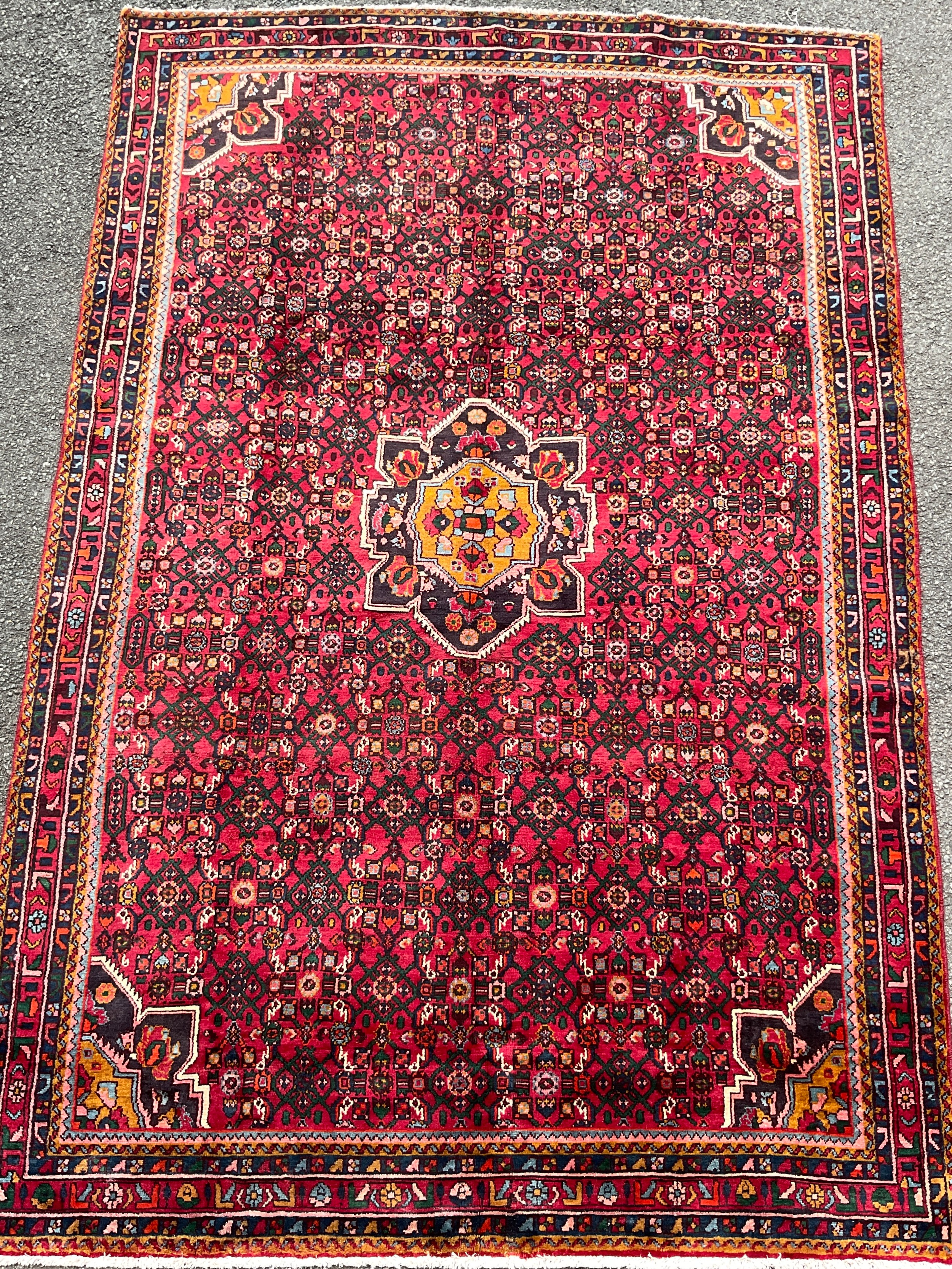 A North West Persian Hussainabad carpet, hand- knotted with central geometric medallion, within a
