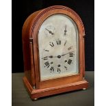 A late 19th century bracket clock, domed top, silvered dial, bold Roman numerals, two subsidiary