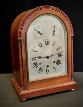 A late 19th century bracket clock, domed top, silvered dial, bold Roman numerals, two subsidiary