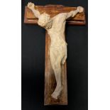 A plaster wall plaque, Christ Crucified, in white on a brown patinated cross and oak back board,