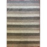 A Catherine Carnaby hand made Varied Stripe Coast pattern wool rug, approx. 160cm x 230cm