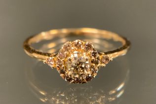 A champagne diamond cluster ring, set with fifteen round brilliant cut diamonds, total estimated