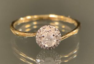 A diamond ring, central round brilliant cut diamond approx 0.18ct, surrounded by a halo of smaller