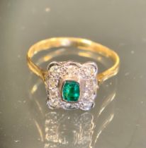 An emerald and diamond ring, central emerald cut rectangular emerald approx 0.15ct, surrounded by