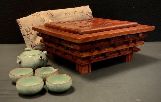 A Chinese tea set in traditional carved wooden box and canvas case.