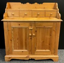 A Scottish style pine small dresser, shaped galleried back, four short drawers to top, with a pair