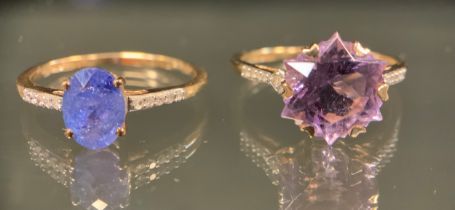 A 9ct gold purply blue stoned possibly tanzanite and diamond ring, oval facet cut pale purply blue