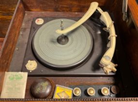 A Garrard RC 120 Mk. II four speed ‘Record changer system’ turn-table, c.1958, in an oak cabinet,