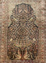 A Persian Isfahan style silk wool mix carpet, knotted ‘Tree of life’ pattern to central field,