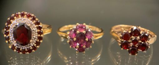 A garnet and white stone oval cluster ring, (possibly Diamonds) 9ct gold shank, Birmingham 2007,