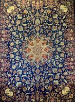 A Meshed carpet, central floral medallion within blue field ground, with floral motifs, the edges