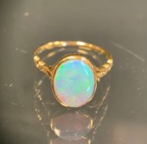 An opal cabochon doublet ring, measuring approx 10.80mm x 8.89mm x 2.94mm, with vibrant green blue