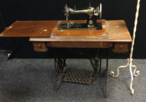 A Singer Treadle sewing machine, C1394618, cast iron base; a wrought iron standard lamp (2)
