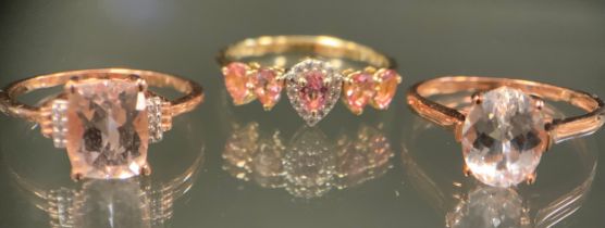 A morganite and diamond ring, central pear drop cluster with a single pear cut morganite