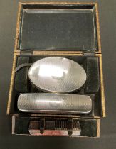 An Art Deco silver gentleman's three-piece brush and comb set, Birmingham, 1929, cased