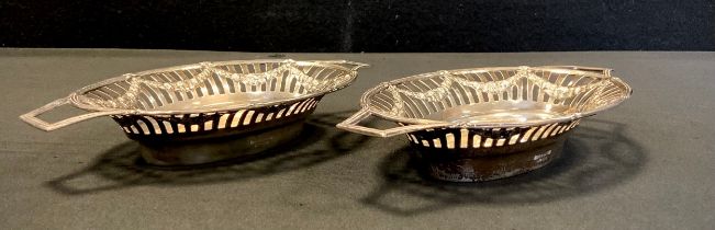 A pair of Edwardian silver twin handled oval bonbon dishes, pierced floral swags, Mappin & Webb,