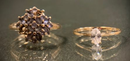 A 9ct gold pale blue stone dress ring, possibly tanzanite, stamped 3.1g gross, missing three stones;