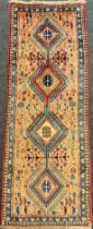 A North West Persian Yallemeh runner carpet, knotted with a row of four diamond-shaped medallions,