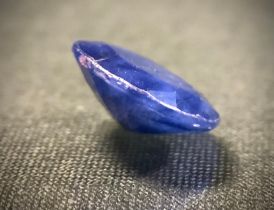 Loose Gemstones- a large oval deep blue sapphire, weight approx 7.70ct, glass filled/treated.