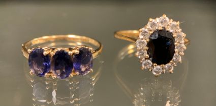 A purply blue stoned trilogy ring, possibly tanzanite, 9ct gold shank, stamped 375 10k, TGGC, size