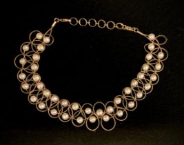 A cultured pearl and yellow metal choker necklace, fine wire lattice adorned with creamy white