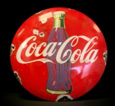 A reproduction Coca-Cola advertising sign, slightly domed circular body , 28cm diameter