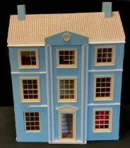 A 20th century three storey dolls house with fitted interior including conforming furniture, etc.