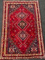 A South West Persian Qashga’i rug / carpet, knotted with traditional stylised figures and abstract