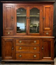 A Victorian Pitch Pine dresser, the top with out-swept cornice over a pair of glazed doors enclosing