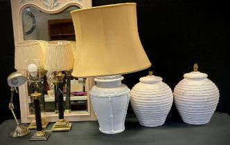 An Italian glazed pottery table lamp, 55cm high; a pair of earthenware Urnular-form table lamps,