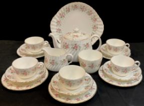 A Minton 'Spring Bouquet' pattern tea service for five comprised of; a tea pot, sugar bowl, milk