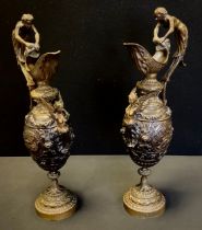 A pair of Italianate baluster-form bronzed-metal ewers, in the classical taste, cast with Nymph