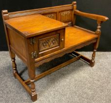 An Old Charm oak hall seat, 74.5cm high x 93cm wide x 51cm deep.