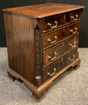 A George III style reproduction mahogany chest of drawers, over-sailing canted rectangular top,