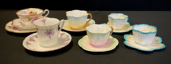 A Collection of Foley China tea cups including dainty Foley China bell-shaped cup, decorated in