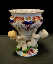 A continental porcelain jardinière, floral band above three mermaid supports, bearing crossed swords