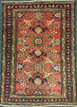 A North West Persian Malayer rug / carpet, hand-knotted with a stylised floral field in red, deep
