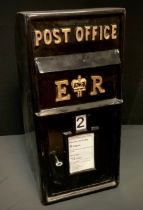 A reproduction black painted metal Post Office type post box, 64.5cm high x 30.5cm wide x 38.5cm