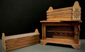 A pair of wooden troughs with metal inserts, each advertising Harrods, Knightsbridge, London, S.W.1;