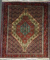 A North West Persian Senneh rug / carpet, hand-knotted in rich tones of red, deep blue, turquoise,