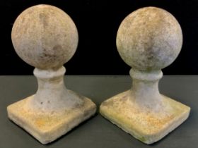 A pair of reconstituted stone ball obelisks, 40cm high.